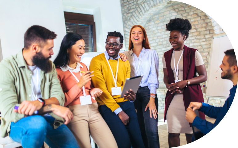 A happy and diverse team that is working together during a leadership training session.