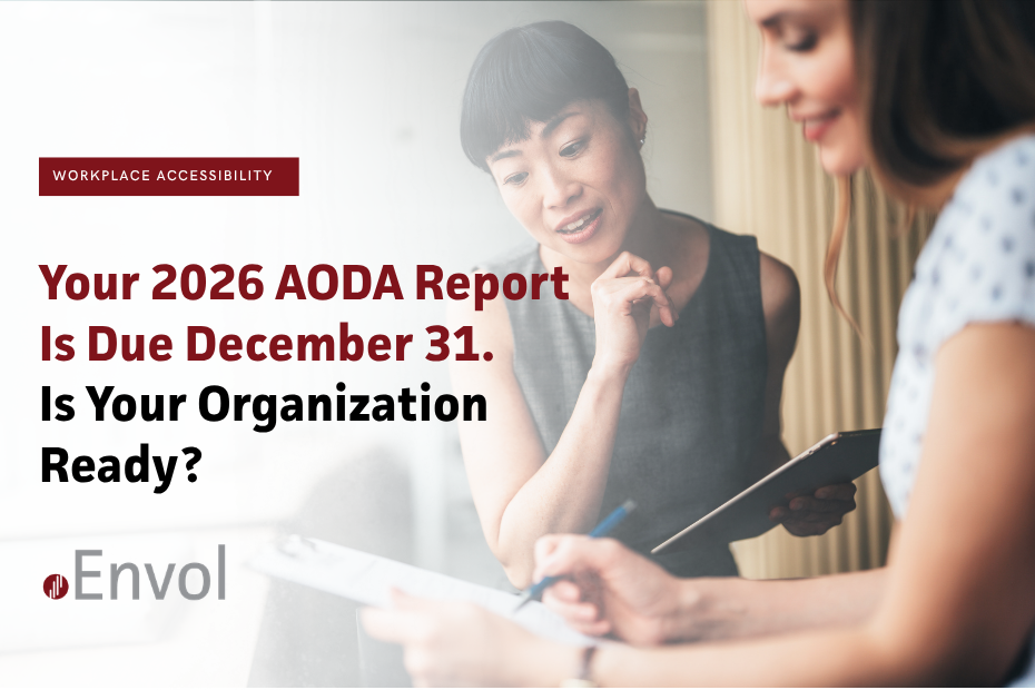 Two women reviewing a clipboard in an office, representing AODA accessibility compliance and reporting readiness.
